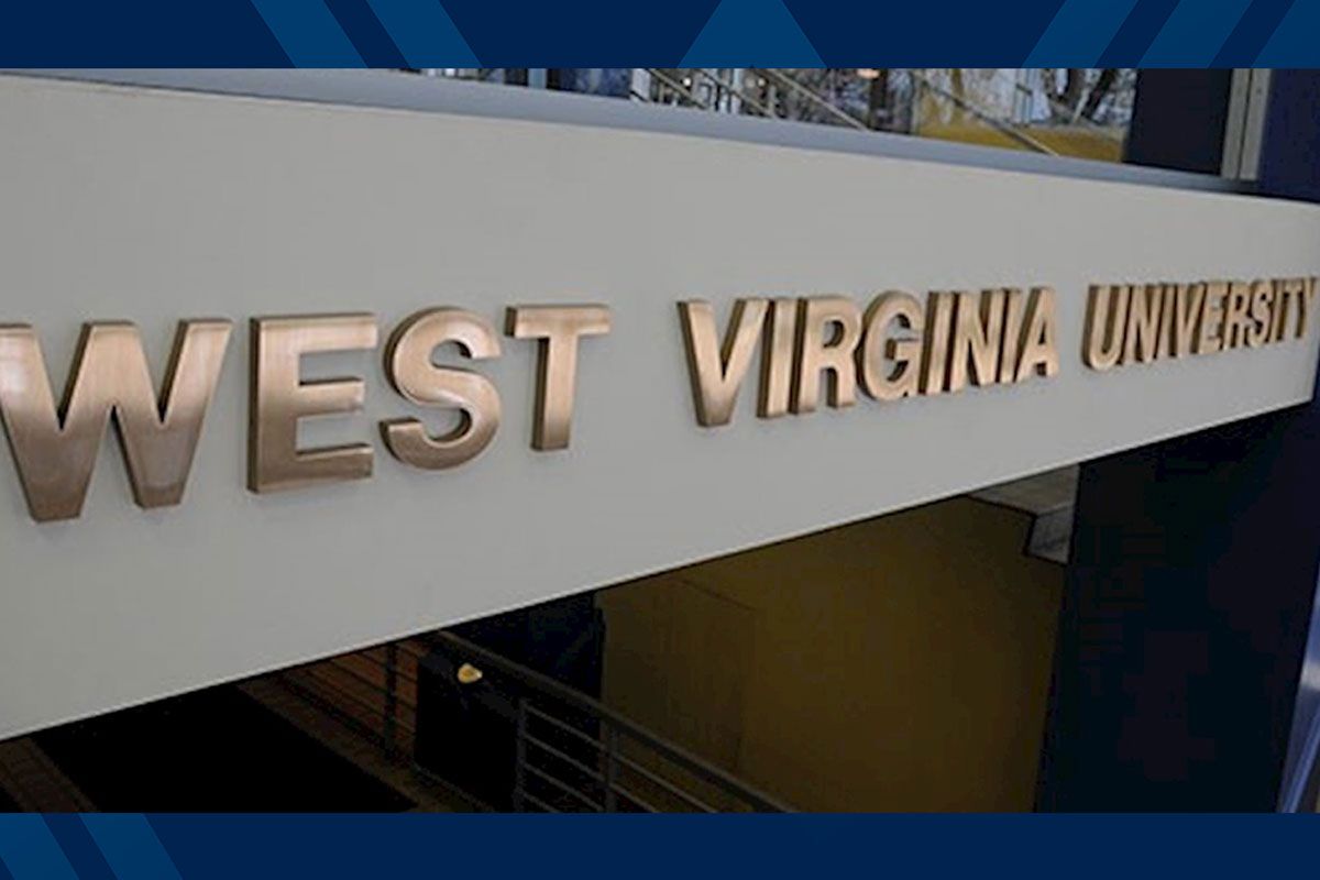 The words West Virginia University on a building in metal letters.
