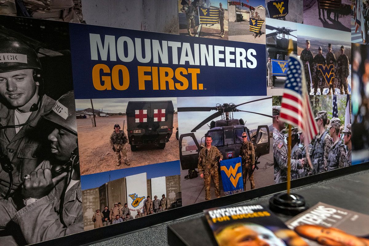 A collage of WVU veteran and military photos with the words Mountaineers Go First overtop of them.