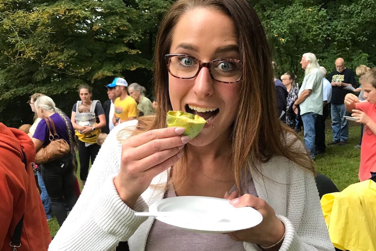 Young woman eating a Pawpaw