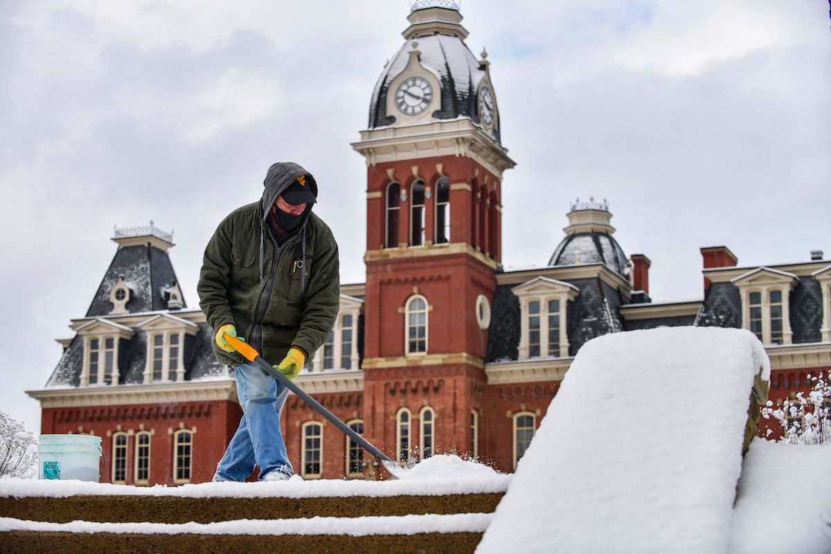 shoveling snow in front of woodburn hall