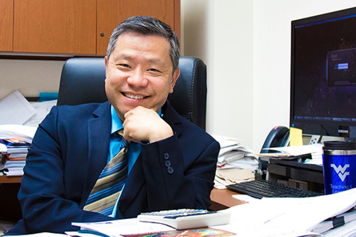 Portrait of Patrick Ma at his desk