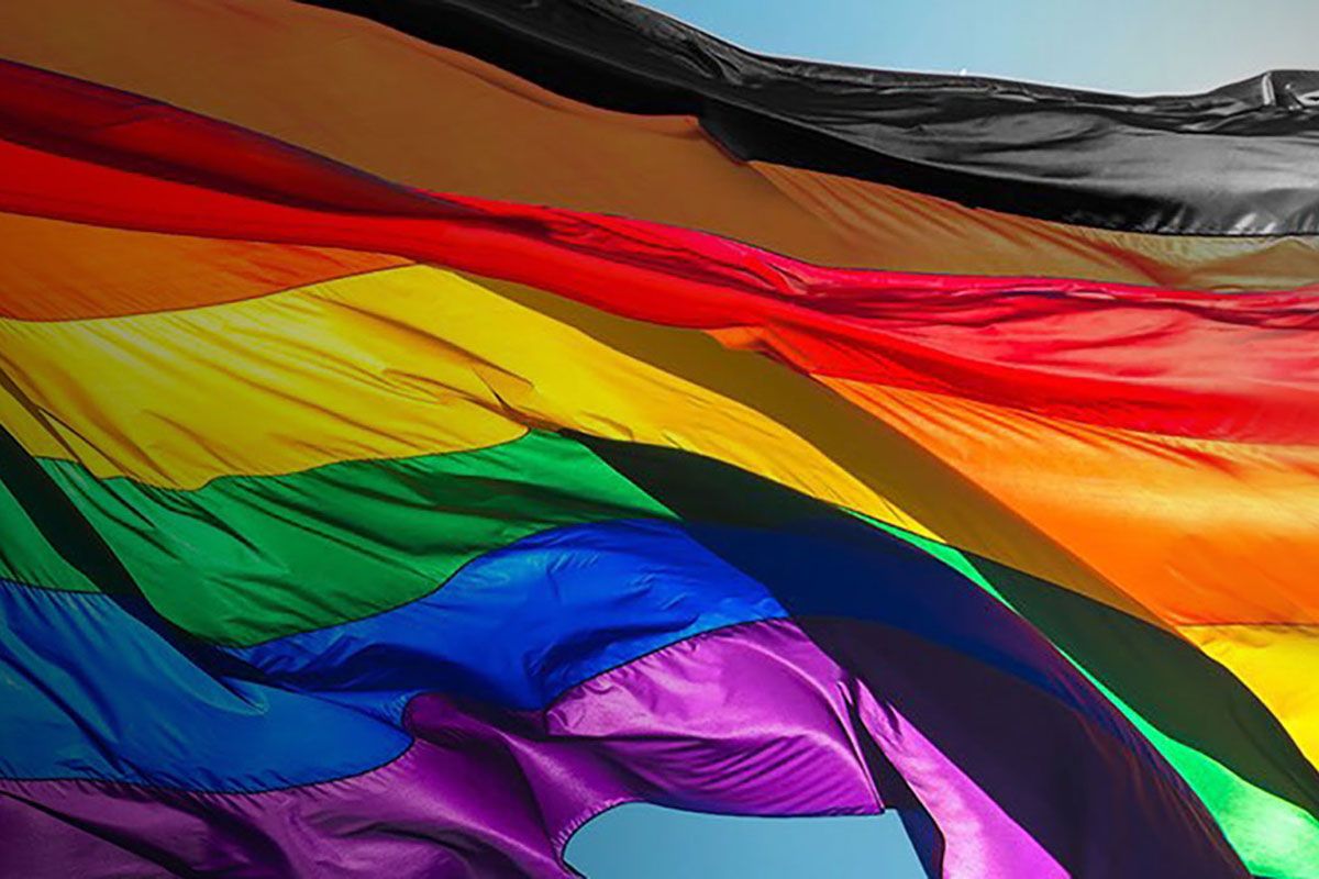 LGBTQ+ flag waving in the wind