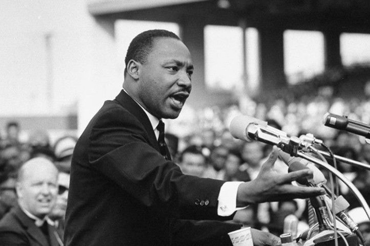 Martin Luther King Jr. speaking at podium.
