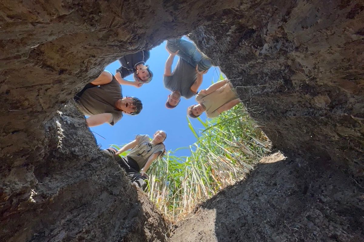 Brzostek Lab Students looking down a hole