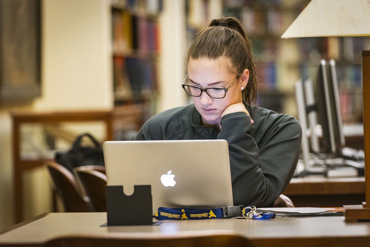 student in library on computer