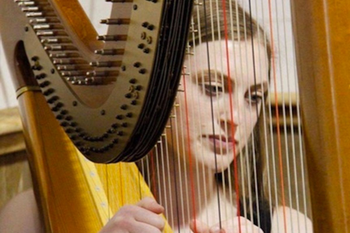 Christine Mazza playing a harp