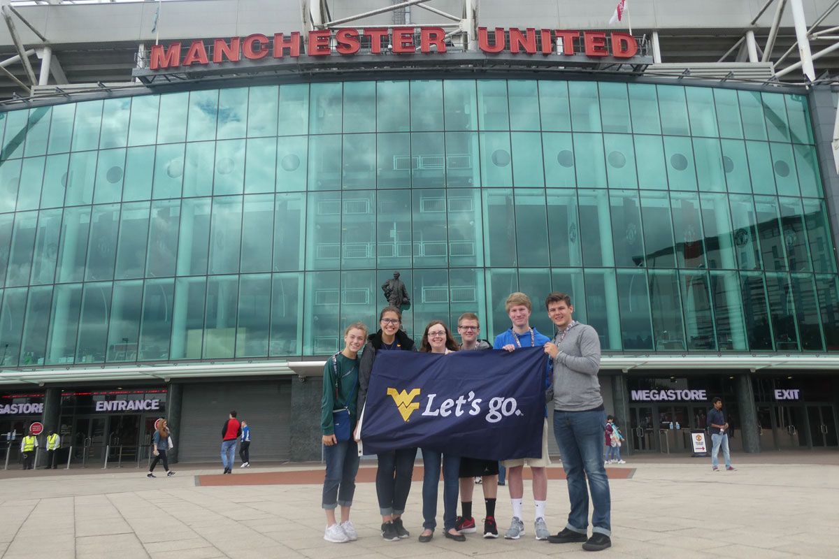Students in front of Manchester United stadium
