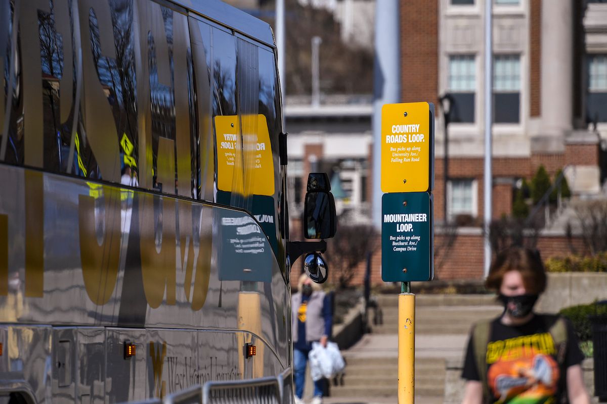 bus on campus and student walking