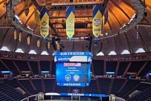 The scoreboard at the Coliseum hangs from the ceiling and includes a graphic Locked Shields 2024.