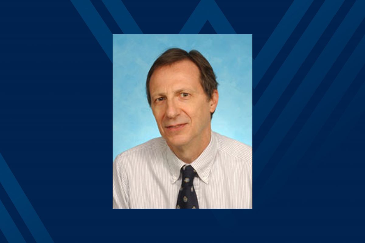 Portrait of Dr. Alan Ducatman on blue background