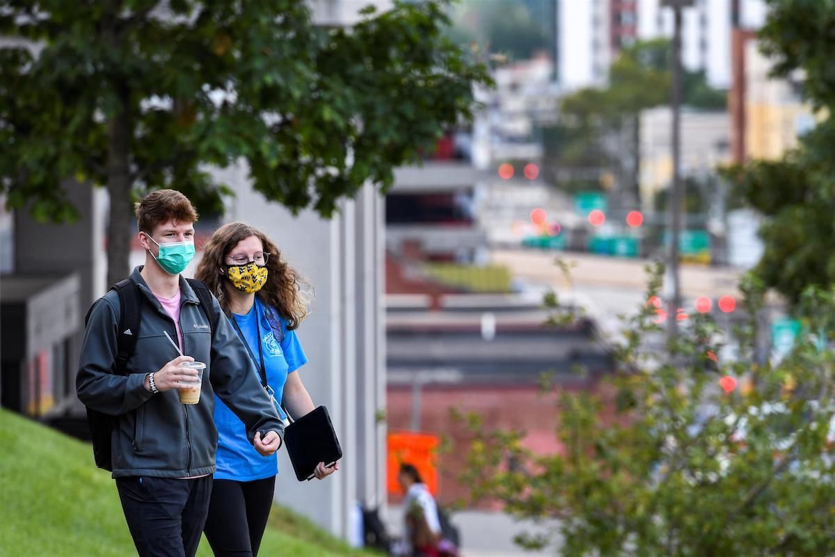 students on campus with masks