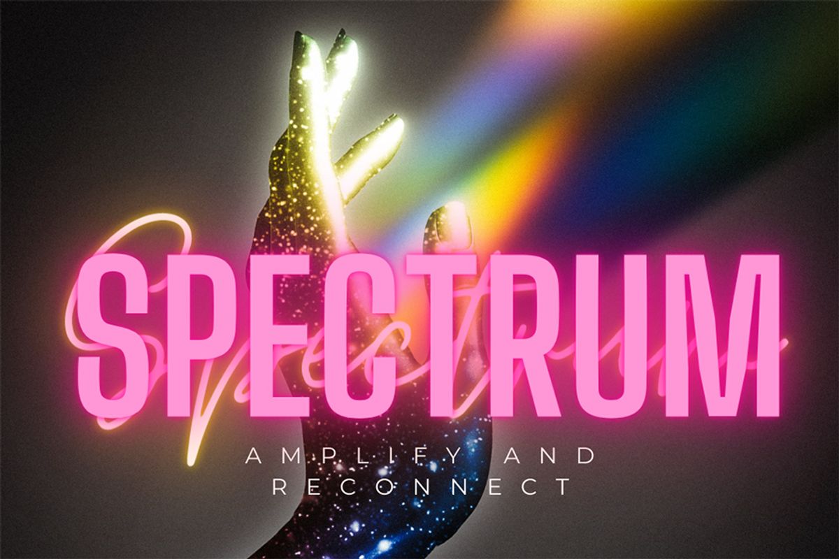The word 'Spectrum' is in pink block letters against a brown background. Behind the letters, a sparkly hand is open to the right. Blue and oranger light pours out of the hand.
