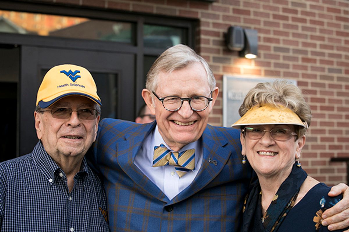 President Gee with Homecoming Award recipients in WVU head gear