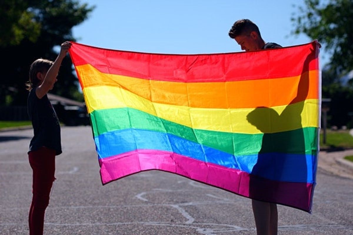 two students with rainbow flag